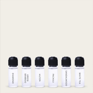 Frascos de aceites para difusor GT Aromas con diferentes fragancias sobre fondo claro.